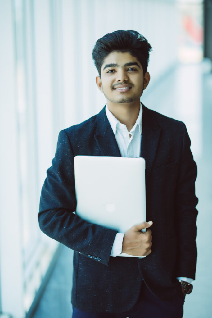 Home portrait of indian happy businessman using laptop computer in office